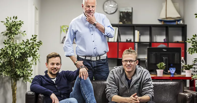 Förmåner utöver det vanliga erbjuder Timeapps vd Lars Knapasjö sina medarbetare – här Elmer Törnquist och Eric Windahl. Lars Knapasjö ståendes bakom soffa med Elmer Törnquist och Eric Windahl.